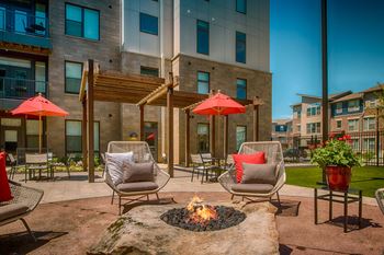 an outdoor patio with chairs and a fire pit  at Avant & Avant II, Carmel, IN